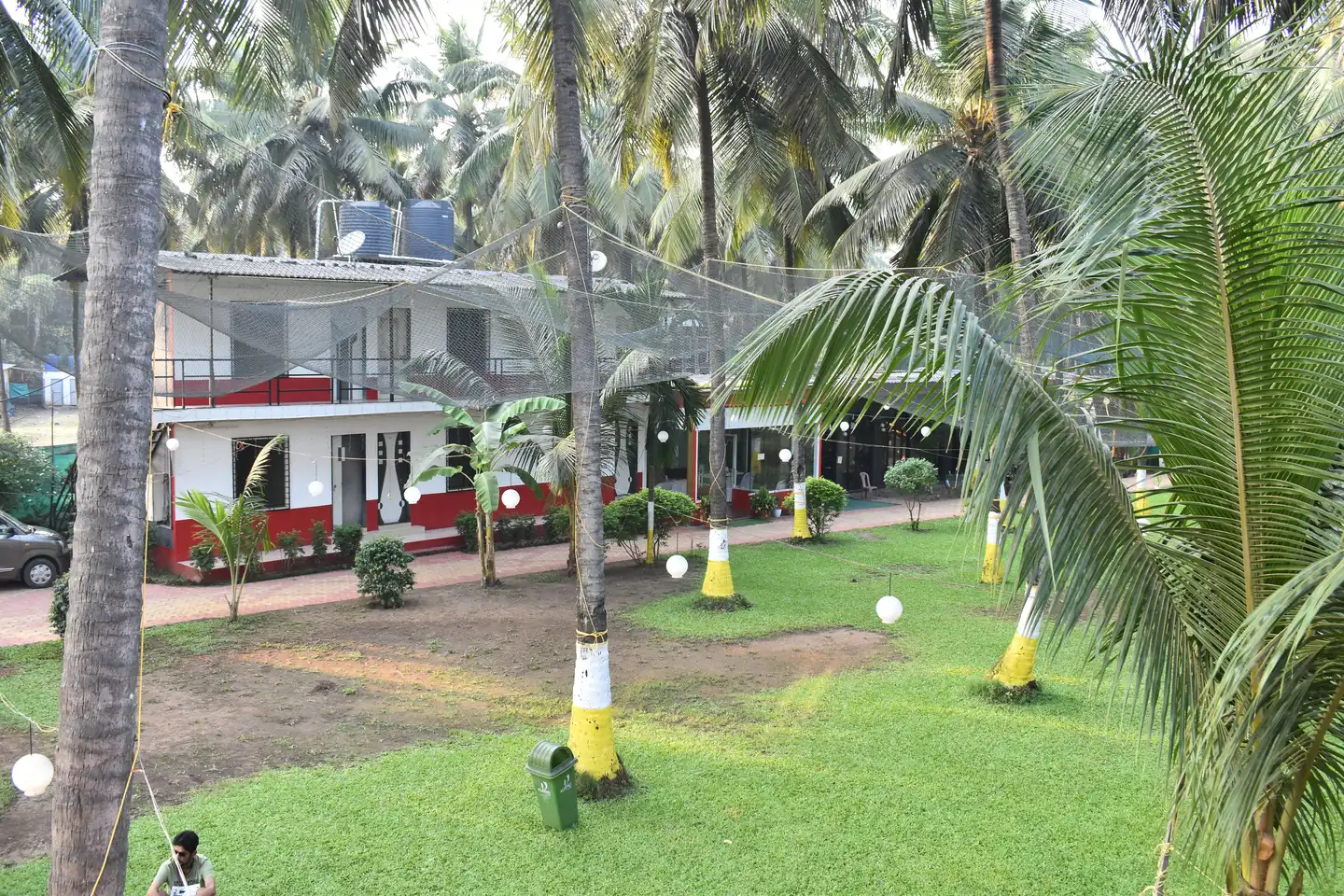 Aerial view of Coconut Valley Resort pool and lush beachfront greenery